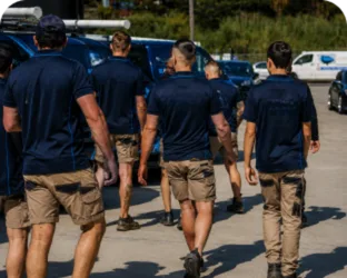 Plumbers walking to their service vans on a Box Hill job